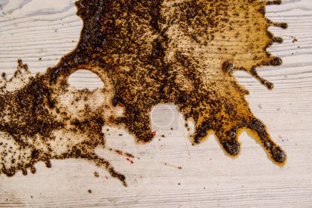 Photo for Coffee stains on white wooden table. Wood texture background. Big dark brown dramatic Splatter, fleck, splash, spot, drops of black coffee. Pattern, wallpaper. Top view.  Closeup. Copy space. - Royalty Free Image