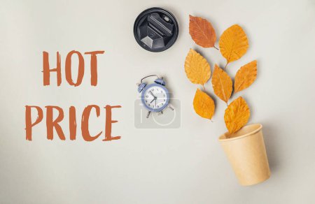 A clock and a cup filled with leaves rest on a table, accompanied by the words hot price underneath, suggesting urgency and value in the context of time and nature.