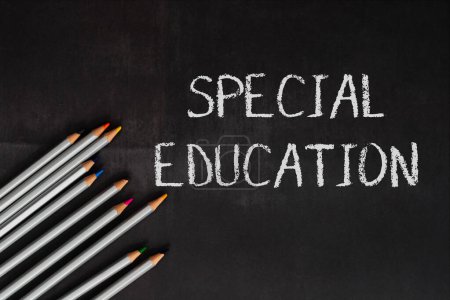 A chalkboard with the word special education written on it. The chalkboard is surrounded by a row of pencils, which are of different colors