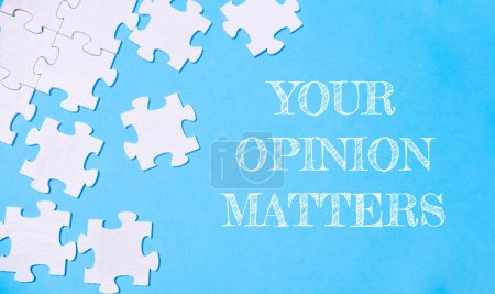 Photo for A puzzle with the words your opinion matters written on it. The puzzle pieces are scattered across the image, creating a sense of disarray and chaos. The blue background adds a calming - Royalty Free Image
