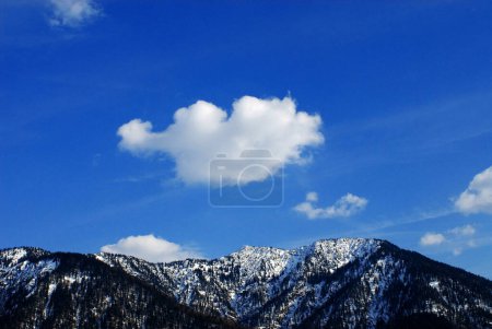white cloud over a snowy mountain top near Fall, Karwendel, Bavaria, Germany
