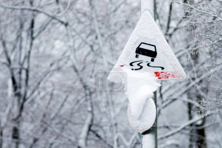 warning sign danger of skidding, snow covered in winter, Munich, Bavaria, Germany