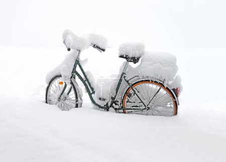 bicycle covered with a thick layer of snow