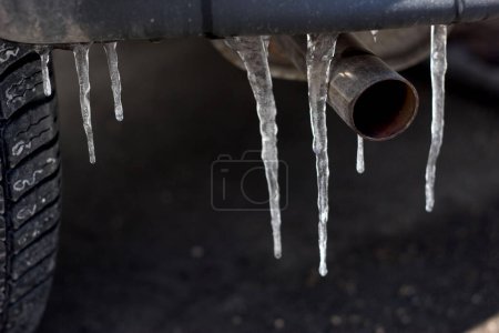 icicle at the muffler of a car symbol for ice rain