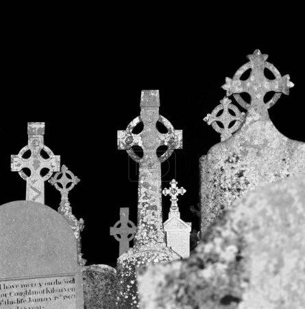 several celtic grave crosses in a cemetery
