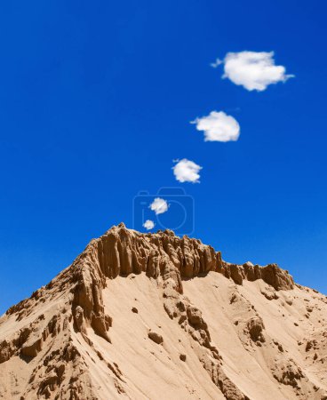 a sandy, rocky mountain, smoke signals in the blue sky