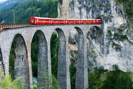 red train of Glacier Express on Viaduct Landwasserviadukt, Filisur, Grisons, Switzerland