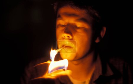 man lights a cigarette
