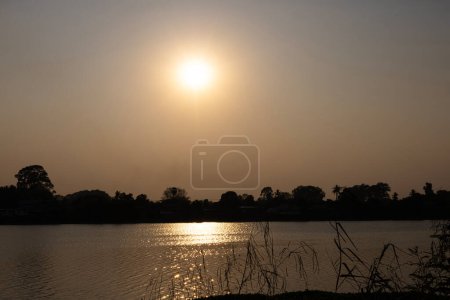 Sun Shine Over River At Sunset. Scenic view of beautiful sunset or sunrise above the river.