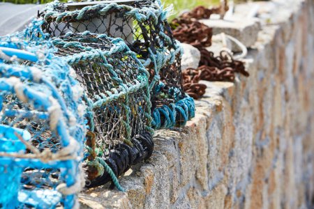 Isles of Scilly, UK - close-up of used lobster traps on a stone wall 