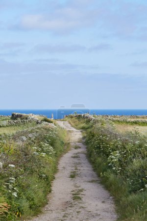 Isles of Scilly, UK - Path to Peninnis Head with ocean in the back and meadows left and right