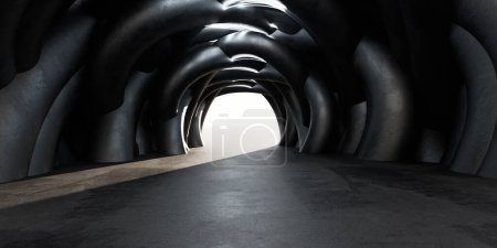 The image shows a tunnel filled with a multitude of black pipes running along the walls and ceiling. The pipes seem to be interconnected, forming a complex network within the tunnels structure.