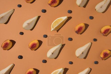 Photo for Creative minimal layout made from sliced pear, peach and blueberry  on pastel background. Flat lay. Pattern concept. - Royalty Free Image