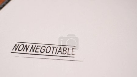 1 photo of black non negotiable stamp inscription on white paper. High quality photo