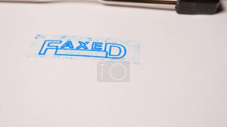 7 photo of blue faxed stamp inscription on white paper. High quality photo
