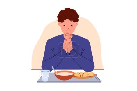 Man prays sitting at table with food, observing christian tradition and expressing gratitude to god. Guy prays with eyes closed and palms folded in front of chest, rejoicing at having money for food