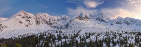 Snowy winter panorama from Hala Gasienicowa with background of majestic Koscielec Mountain and blue sunny sky in Gasienicowa valley in the Tatra National Park.