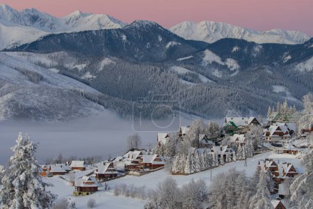 Beautiful winter morning view with mountains in the background. View of the Tatra Mountains, Zakopane Town and Koscielisko Village in Poland country.
