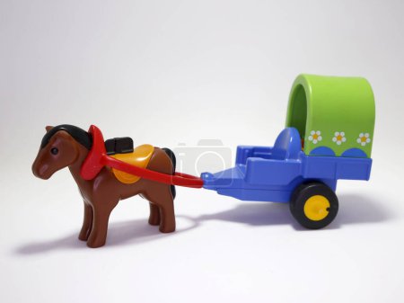 Photo for Toy for children Playmobil horse with cart. Fun for young children. Means of transportation using animals. White background with copy space. - Royalty Free Image