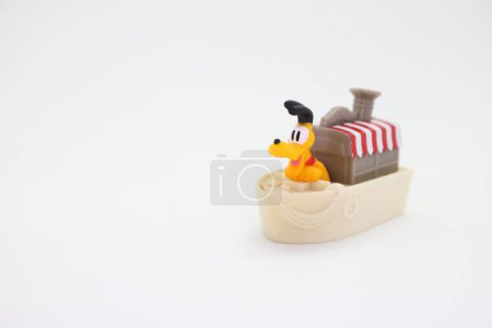 Photo for Collectible toy for children on white background isolated with copy space. Pluto the dog sailing on a steamboat at the Disney World parks. - Royalty Free Image