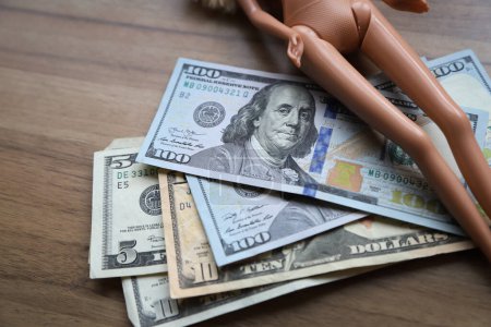 Konzeptbild von Pädophilie und Kinderprostitution. Geld und Spielzeug. Illegale Geschäfte.