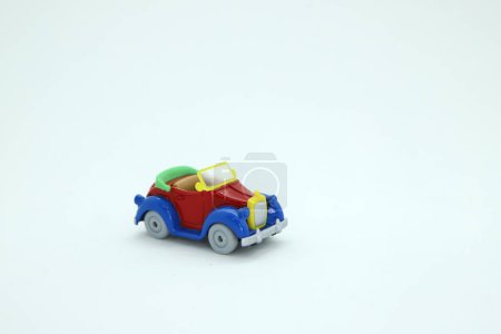 Photo for Toy car in primary colors: red, yellow and blue. Isolated white. Background with copy space. Donald Duck toy car. - Royalty Free Image