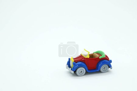 Photo for Toy car in primary colors: red, yellow and blue. Isolated white. Background with copy space. Donald Duck toy car. - Royalty Free Image