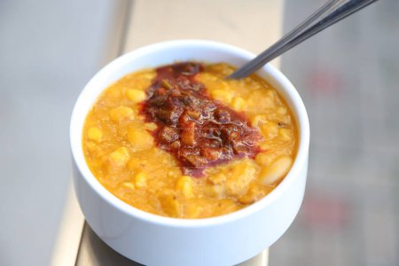 Locro. Typical Argentine food of national dates. Gourmet dish composed of pumpkin, beans, meat and other ingredients. Isolated. Light background. Traditional lunch or dinner.