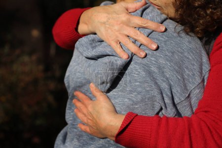 Großmutter umarmt ihren Enkel. Familienliebe. Affektive Bindungen. Tröstliche Umarmung. Bindeglied der Generationen. bedingungslose Liebe. Pflege und Schutz der Menschen. Familienglück. Gegenseitige Unterstützung. Leitfaden für Teenager