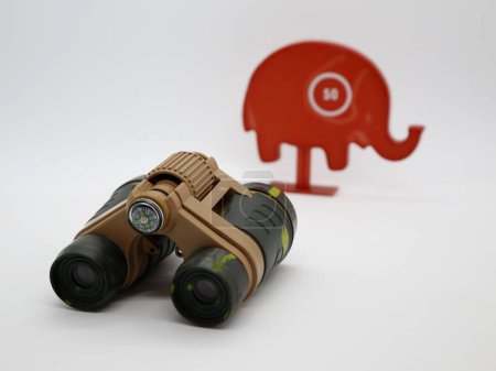 Targets. Concept image. Hunter looking at his prey. Safari to hunt wild animals. Elephant hunting. Look through binoculars. Illegal hunting. Hunting targets. Camouflage.