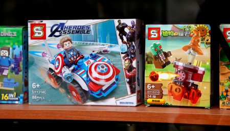 Photo for Toys of Chinese origin imitation of toys of famous people. Lego-type toys. Captain America, Plants versus zombies, Minecraft. Boxes of children's toys in a toy store window. Fake toys. - Royalty Free Image