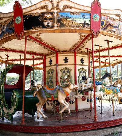 Photo for Merry-go-round. Carousel. Playground. Traditional game for children. Amusement park. A merry-go-round with horses, reindeer and sleigh. Old classic style. Fun and entertainment. Game for young kids - Royalty Free Image