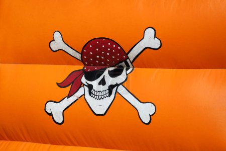Pirate skull. Inflatable castle in the shape of a pirate ship. Outdoor game for children. Fun for boys and girls. Children's birthday. Fun in amusement park. Childhood. Children's party.