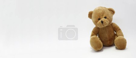 Photo for Banner with brown teddy bearCute toy for babies and toddlers. Soft toy for children Horizontal banner with white background. Isolated. Graphic resource to births, birthdays, baby rooms. Classic teddy - Royalty Free Image