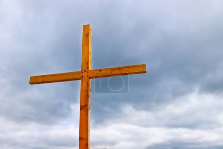Wooden cross with the sky in the background. Religious symbol of Christianity. Catholic Cross.