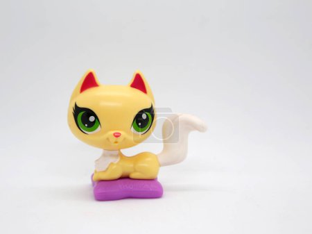 Photo for Littlest pet shop. Kitten with big green eyes on her pillow. Toy for girls and boys - Royalty Free Image