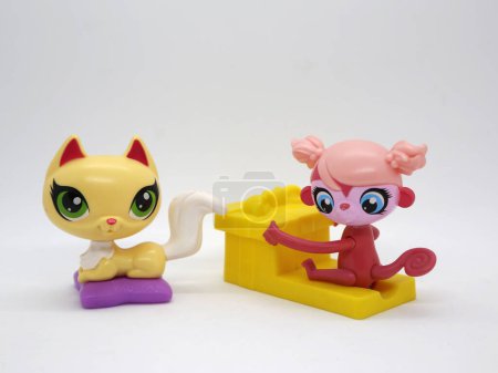 Photo for Littlest pet shop. Kitten with big green eyes on her pillow. Monkey with big blue eyes with a gift. Toy for girls and boys. McDonal's happy meal toy. - Royalty Free Image