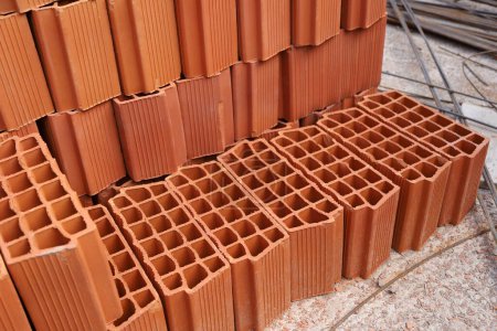 Roof bricks. Thermal ceramic brick. Bricks for construction of houses and buildings. Concept of construction, building, works of architecture, urban plan.
