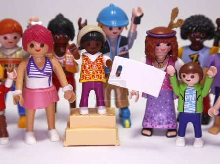Photo for Playmobil toys dolls. People demonstrating. Diversity of people making a claim. People of many races and ages. Blank banner. Grouping of people. Festival. Children and adults. Men and women. - Royalty Free Image