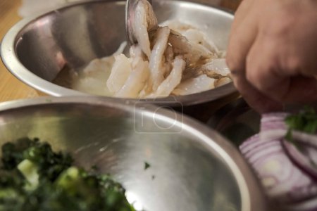 Photo for Close up of hands of chef cooking food in kitchen - Royalty Free Image