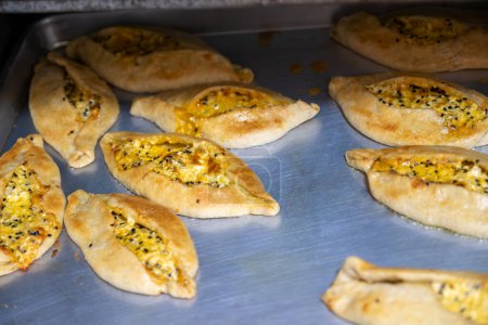 Photo for Pastries in oven being baked and freshly made of flour, olive oil and cheese, made according to jordan and palestine way - Royalty Free Image