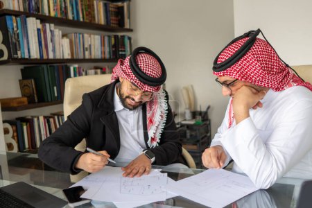 senior arab  supporting junior during work