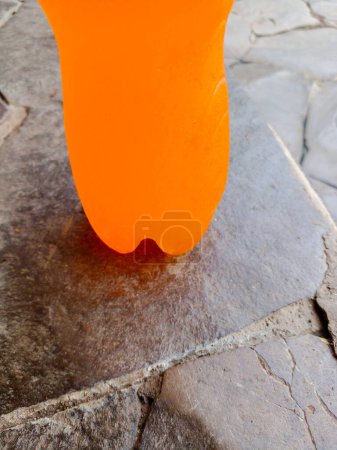 Photo for Cold orange drink on stone background. Orange drink in bottle. - Royalty Free Image