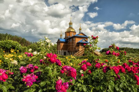 Photo for Convent in Ukraine. Convent of the Athos Icon of the Mother of God in the Kipyachee tract. Orthodox Church and lush rose bloom - Royalty Free Image
