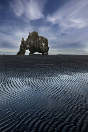 Photo for Hvitserkur is a rock on the north coast of Iceland at low tide. Famous tourist spot on the coast of Iceland. ribbed pattern on the sand at low tide. - Royalty Free Image