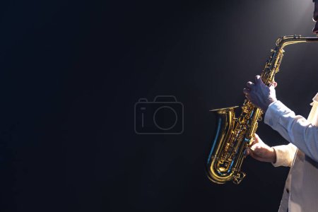 Photo for Male musician on stage plays the saxophone dark with smoke, copy space. - Royalty Free Image