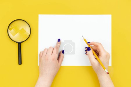 Photo for Blank sheet of paper in female hands on a yellow background, flat lay, concept of hobies, work and creativity, copy space. - Royalty Free Image