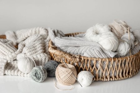 Photo for Basket with yarn close-up, pastel color threads for knitting on a blurred white background. - Royalty Free Image