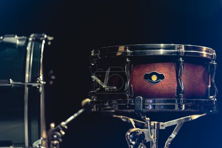 Photo for Snare drum on a blurred dark background, part of a drum kit. - Royalty Free Image