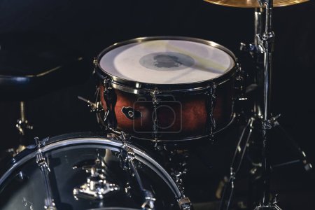Snare drum on a blurred dark background, part of a drum kit, music concert cncept.
